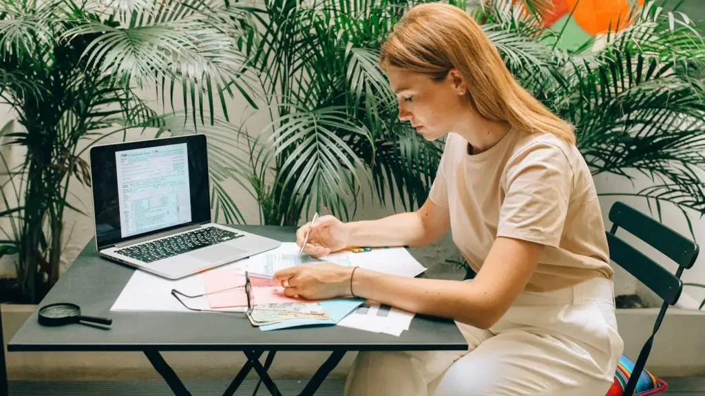 Woman working on laptop outdoors