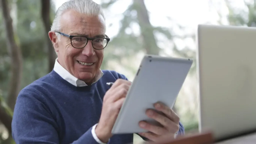 Senior man using electronic signature on tablet