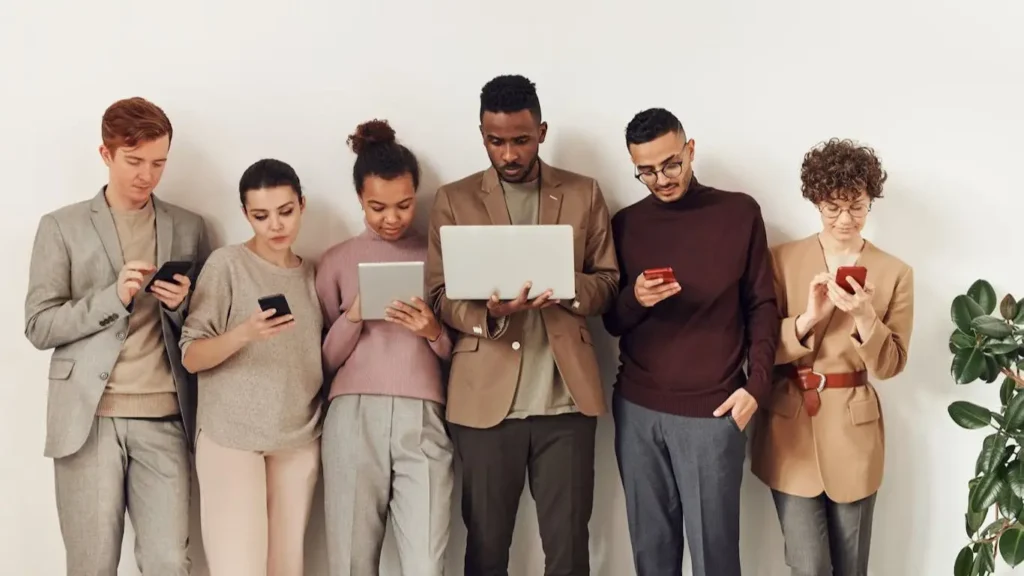 Group of people using different digital devices