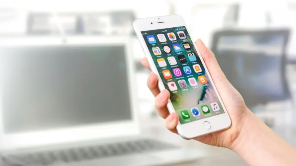 Hand holding smartphone with apps